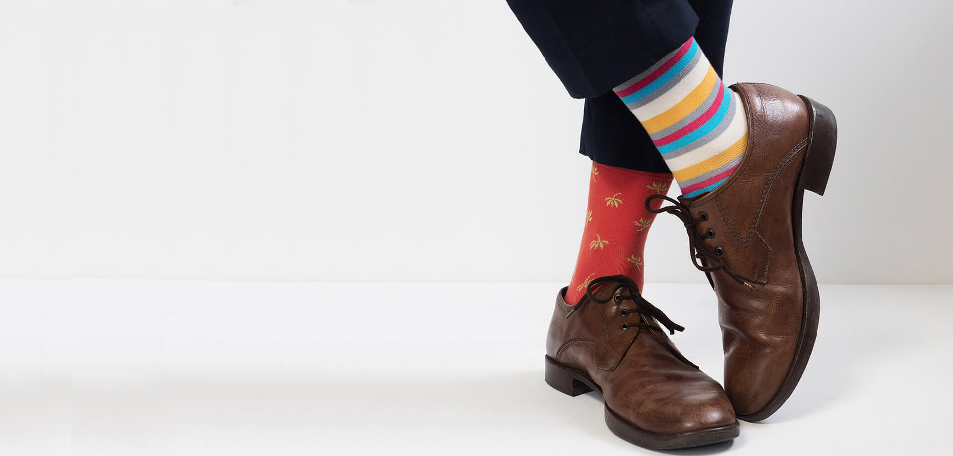 Brown formal shoes paired with colourful socks